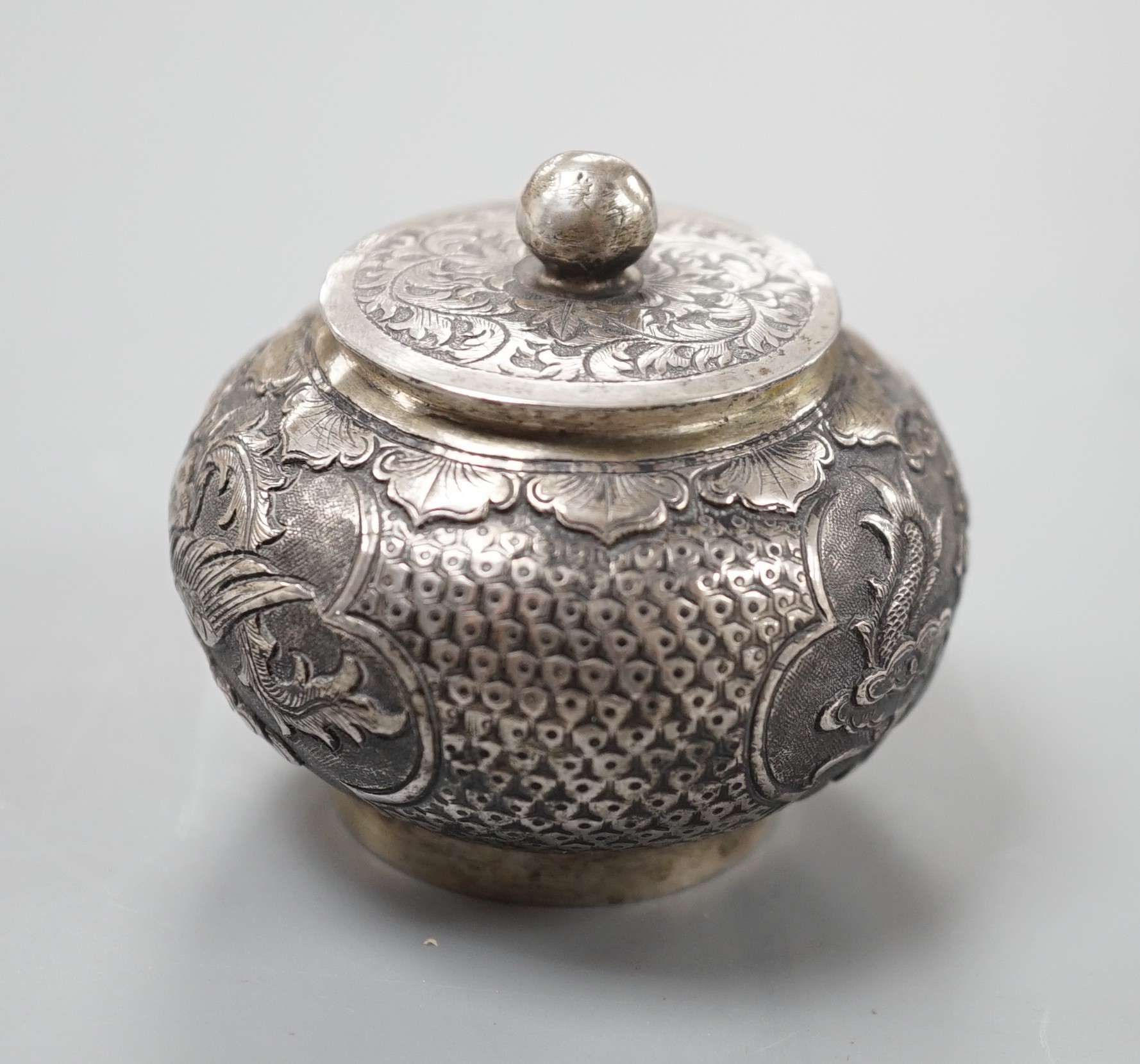 A Chinese white metal unsigned pot and cover, 5cms high.